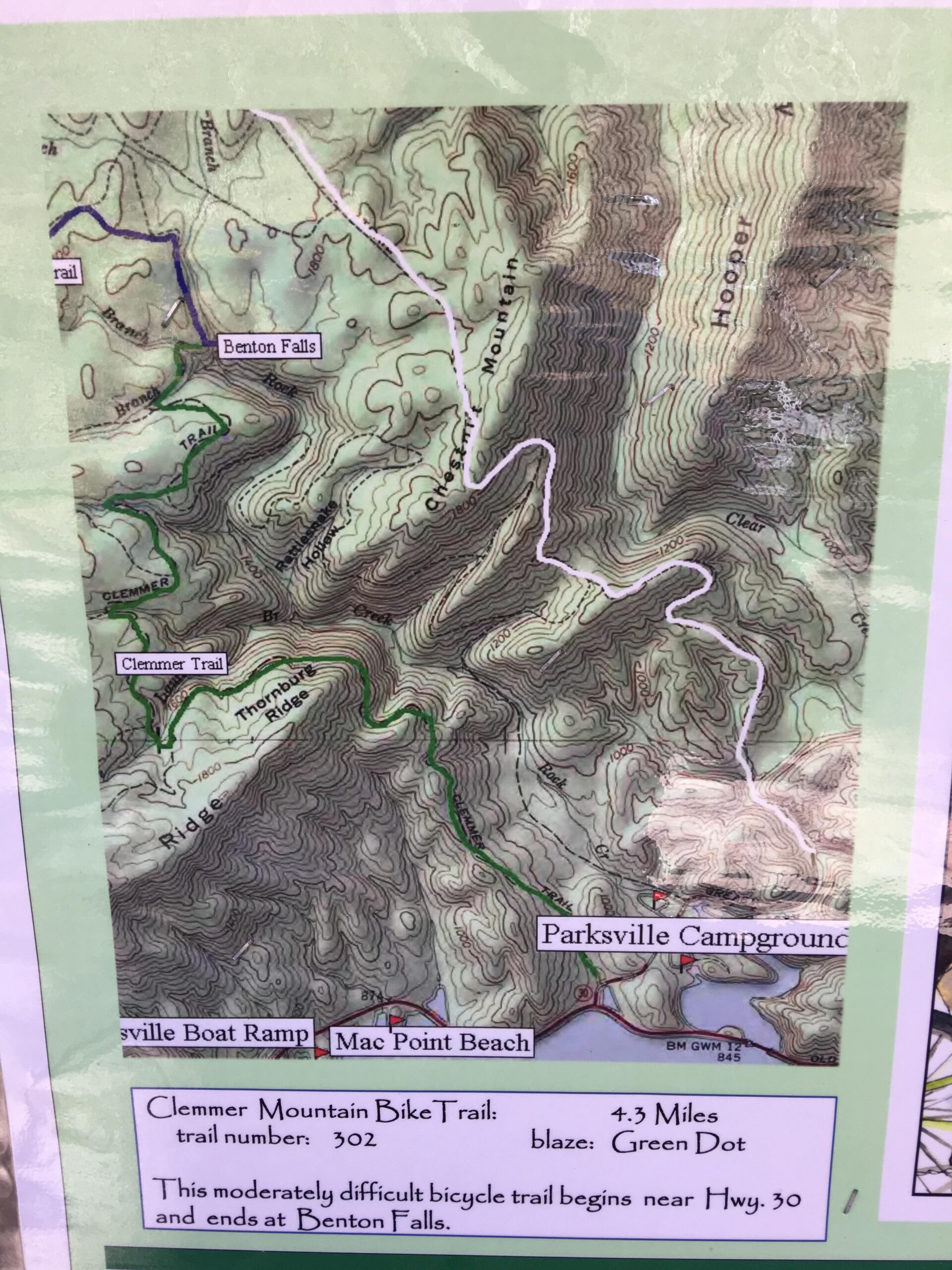 Map of the Clemmer Mountain Bike Trail, showing a 4.3-mile route marked with a green dot. The map features topographical details, including elevation contours, nearby locations such as Benton Falls, Parksville Campground, and Mac Point Beach, and connecting trails. Chilhowee trail system mountain bike trail.