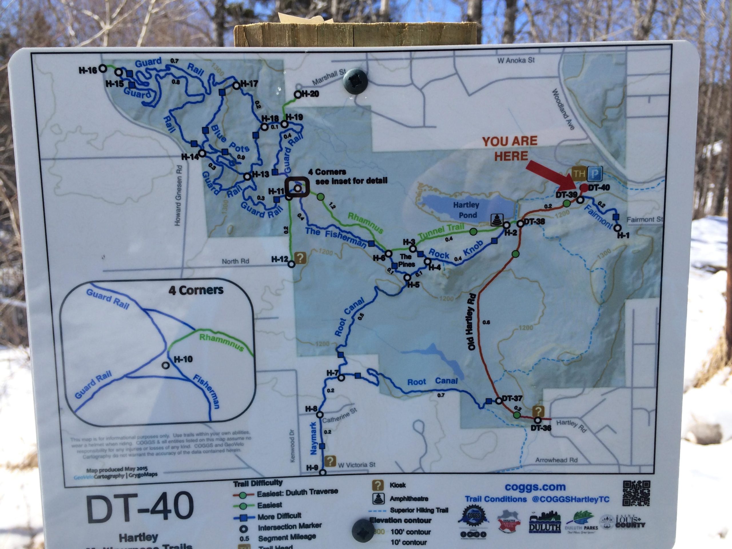 Map of Hartley Park trails, indicating various routes and their difficulty levels, with a marker showing "You Are Here." The map includes trail names, intersections, and nearby features such as Hartley Pond. Snow is visible in the surrounding area. Hartley Park mountain bike trail.