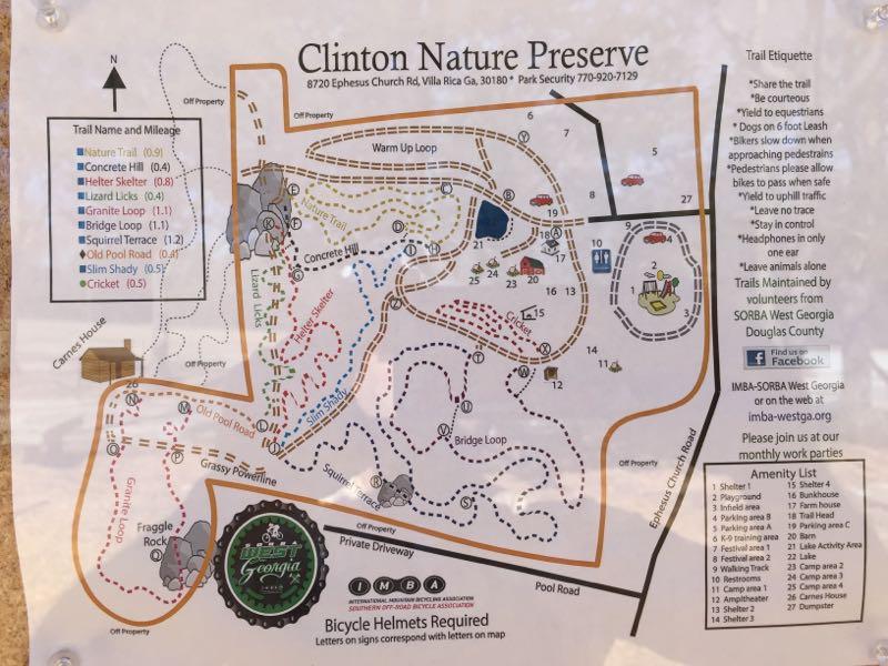 Map of Clinton Nature Preserve featuring various hiking and biking trails, along with trail names and mileages. The map includes trail etiquette guidelines, an amenities list, and a note about bicycle helmet requirements. Key landmarks are denoted, and different loops and paths are indicated with dotted lines. Clinton Nature Preserve mountain bike trail.