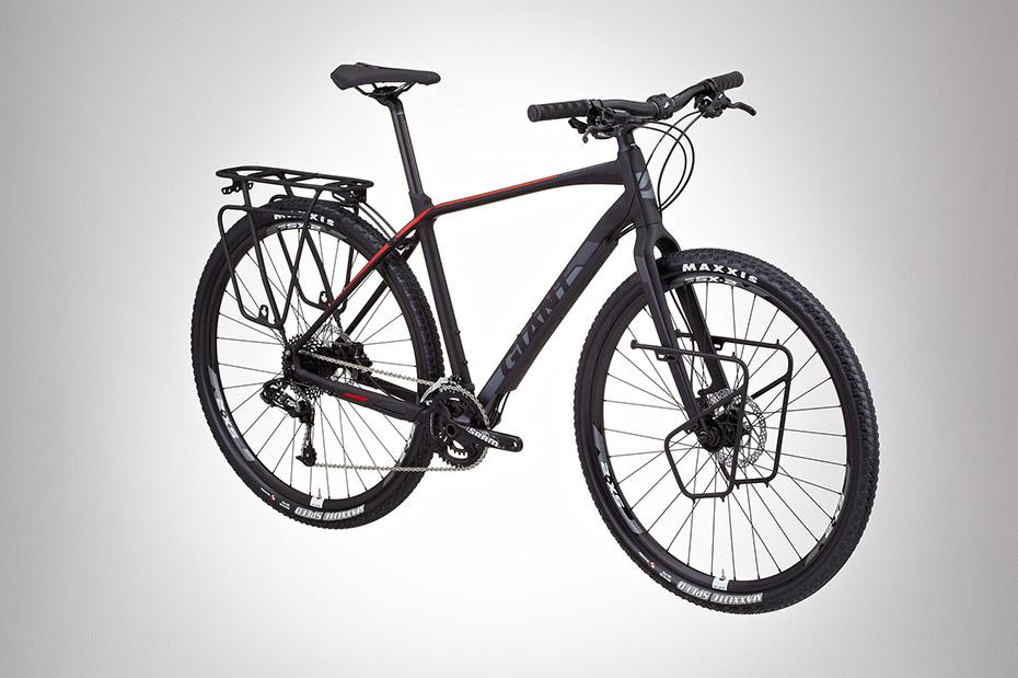 Giant XTC 29er: A modern black and red mountain bike featuring a sleek frame, disc brakes, and a rear rack for carrying cargo. The bike is positioned on a light gray background, highlighting its design and components.