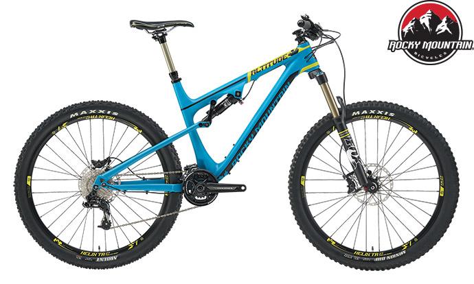 Rocky Mountain Altitude: A blue and yellow Rocky Mountain Altitude mountain bike with large, knobby tires and a lightweight frame. The bike features front suspension, disc brakes, and is equipped for off-road use. The Rocky Mountain logo is visible in the upper right corner.