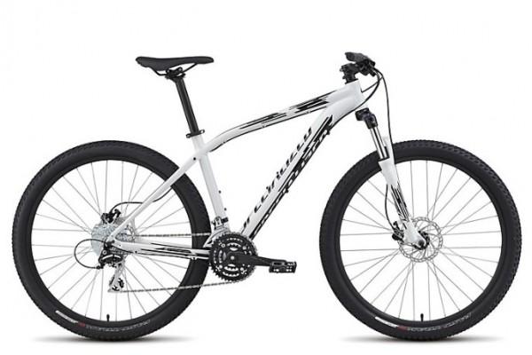 Specialized Pitch 650b: A white mountain bike with black accents, featuring thick tires, disc brakes, and a lightweight frame. The bike has a sleek design, with a straight handlebar and gear shifters, making it suitable for off-road cycling.