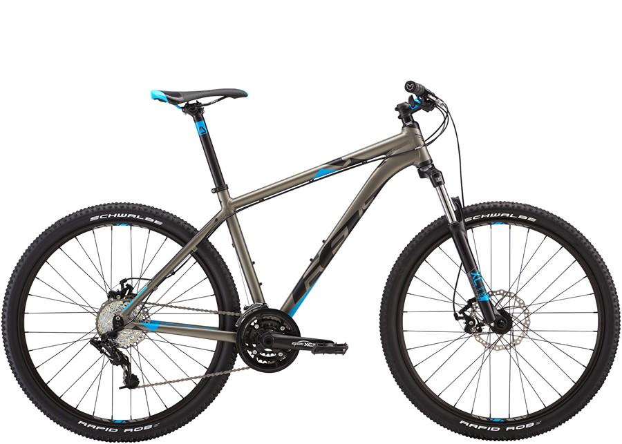 Felt 7 Eighty: A modern mountain bike featuring a sleek gray frame with blue accents, equipped with wide tires suitable for off-road terrain, a front suspension fork, and multiple gears for varied riding conditions.