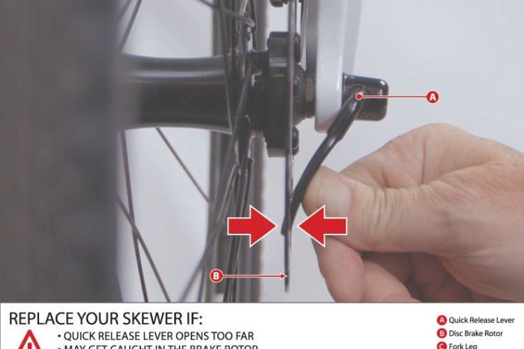 A close-up image showing a hand adjusting the quick release lever on a bicycle wheel. The focus is on the quick release mechanism near the disc brake rotor, with arrows indicating key components: the quick release lever (A), disc brake rotor (B), fork leg (C), and brake caliper (D). A warning message is included at the bottom, advising to replace the skewer if the lever opens too far, may catch in the brake rotor, or may cause the front wheel to lock up suddenly.