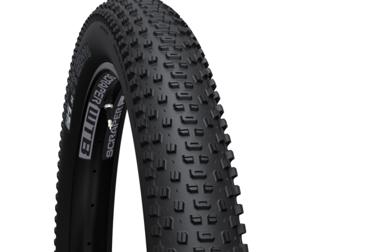 A close-up image of a mountain bike tire, showcasing its rugged tread design and sidewall details. The tire is black with distinctive knobs for enhanced grip on various terrains, featuring branding on the side.