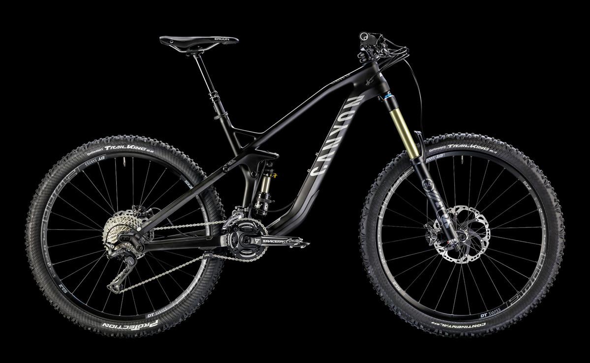 Canyon Strive CF: Alt text: A black mountain bike with a sturdy frame, featuring wide tires, a front suspension fork, and a rear shock. The bike showcases detailed components including shifters and disc brakes, set against a black background.