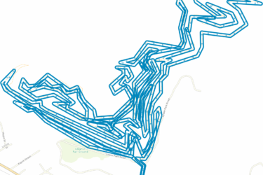 A detailed map showing a complex, winding path marked in blue, representing a route taken through an open area near Eleanor Fair Ground. The background is mostly white with some roads and street names visible. The path includes numerous twists and turns, creating an intricate pattern. Eleanor Park mountain bike trail.