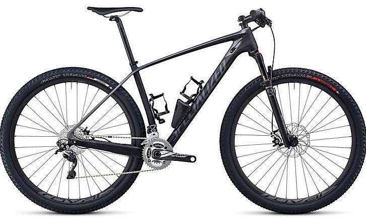 Specialized Stumpjumper Comp: A black mountain bike with a lightweight frame, wide tires, and dual water bottle holders, displayed against a neutral background. The bike features a suspension fork, disc brakes, and a gear system suitable for off-road cycling.