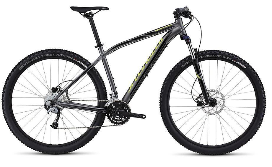 Specialized Rockhopper 29: A black and gray mountain bike with a lightweight frame, designed for off-road terrain. It features thick tires suitable for varied surfaces, a front suspension fork, and a detailed gear system. The handlebars are positioned for a comfortable grip, and the bike is showcased against a plain background.