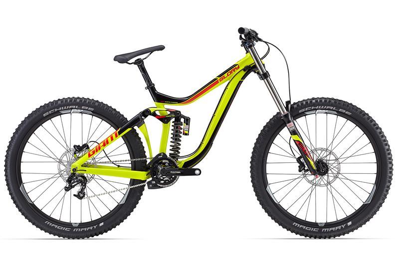 Giant Glory 2: A vibrant yellow and black mountain bike featuring a dual-suspension design, wide tires, and disc brakes, positioned at an angle to showcase its sleek frame and components. The bike is labeled "Glory" and is built for downhill and trail riding.