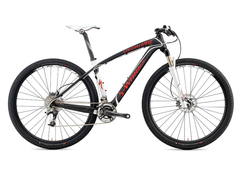 Specialized S-WORKS STUMPJUMPER HT: A black and red specialized mountain bike featuring a sleek frame, disc brakes, and thick tires. The bike is shown from a side angle, highlighting its design and components, including the gear system and suspension fork.