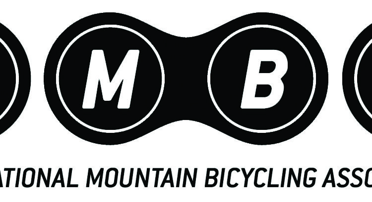 Logo of the International Mountain Bicycling Association (IMBA), featuring the letters "I," "M," "B," and "A" arranged in circular shapes. Below the letters, the full name of the association is written in a bold font. The design uses a black and white color scheme.