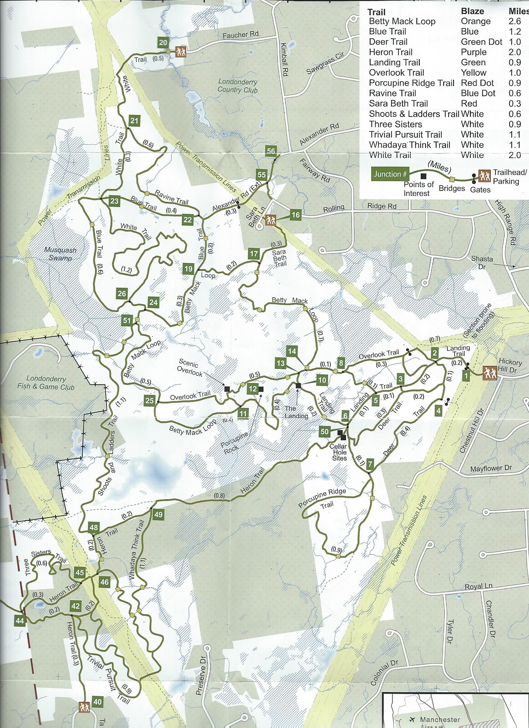 Map of trails in a park, featuring various paths with labels for trail names, distances, and difficulty levels. The map includes a legend indicating trail markings such as colors and symbols, as well as points of interest, junctions, and parking areas. Musquash Conservation Area mountain bike trail.