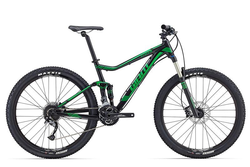 Giant Giant Stance 2: A green and black mountain bike with a full suspension design, featuring wide tires labeled Maxxis and a sleek frame. The front fork is visibly designed for shock absorption, and the bike has a modern look with a shiny finish.