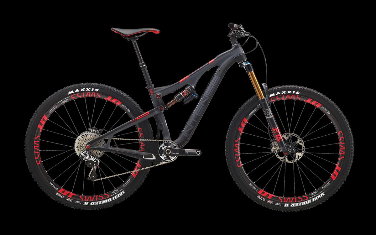Intense Carbine 29: A sleek mountain bike with a black and red color scheme featuring dual suspension, thick tires with Maxxis branding, and DT Swiss wheels. The bike is shown at a side angle, highlighting its modern design, adjustable seat, and advanced suspension components. The background is solid black, emphasizing the bike's features.