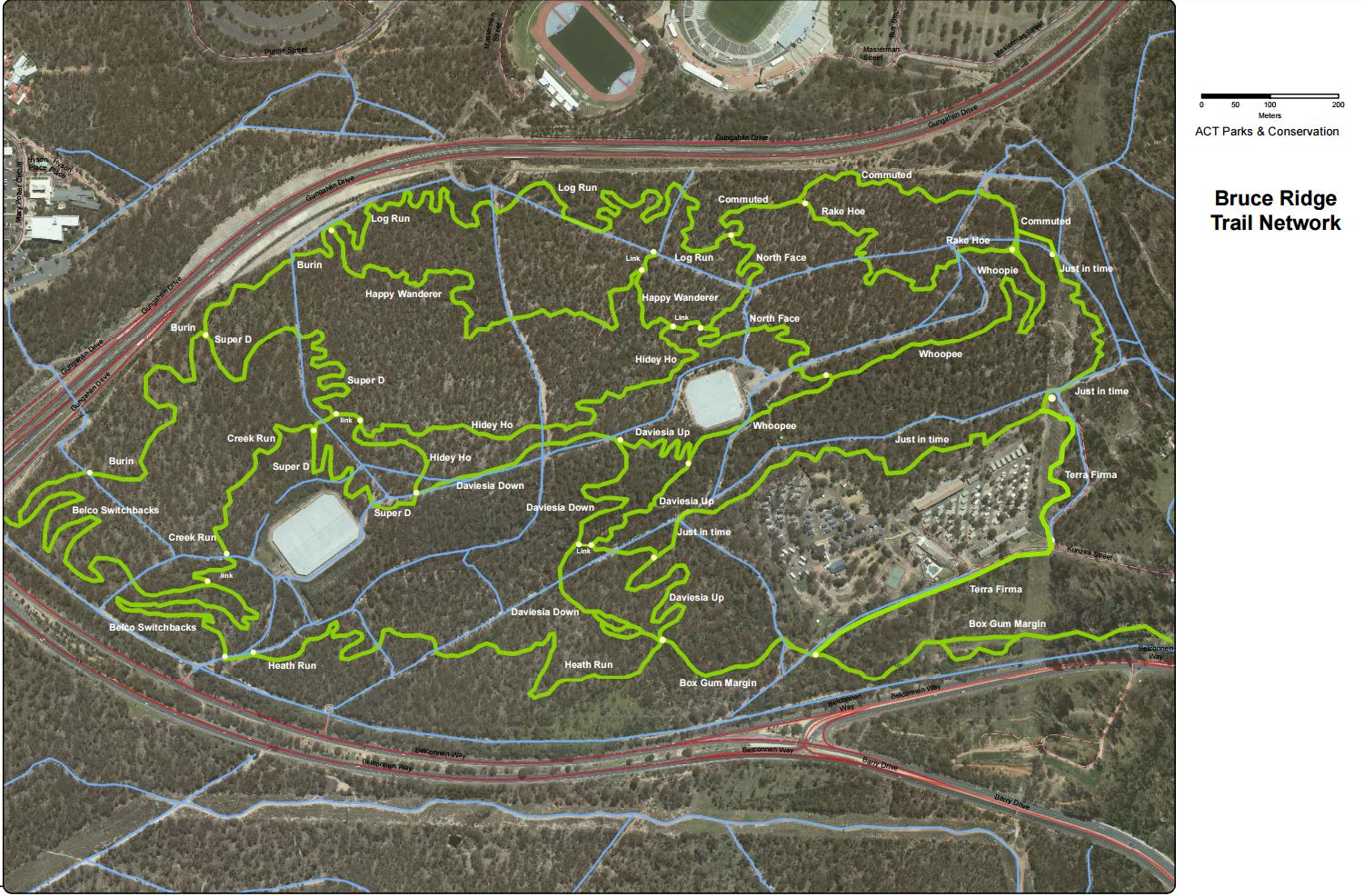 Map of the Bruce Ridge Trail Network, featuring various trails marked in bright green on a satellite view of the area. The map includes labeled trails such as "Happy Wanderer," "Super D," and "Daviesia Up," along with blue roads and pathways. Key landmarks and features in the surrounding landscape are also indicated. Rossii Loop mountain bike trail.
