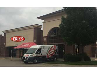 Image of a storefront with a large sign reading "ERIK