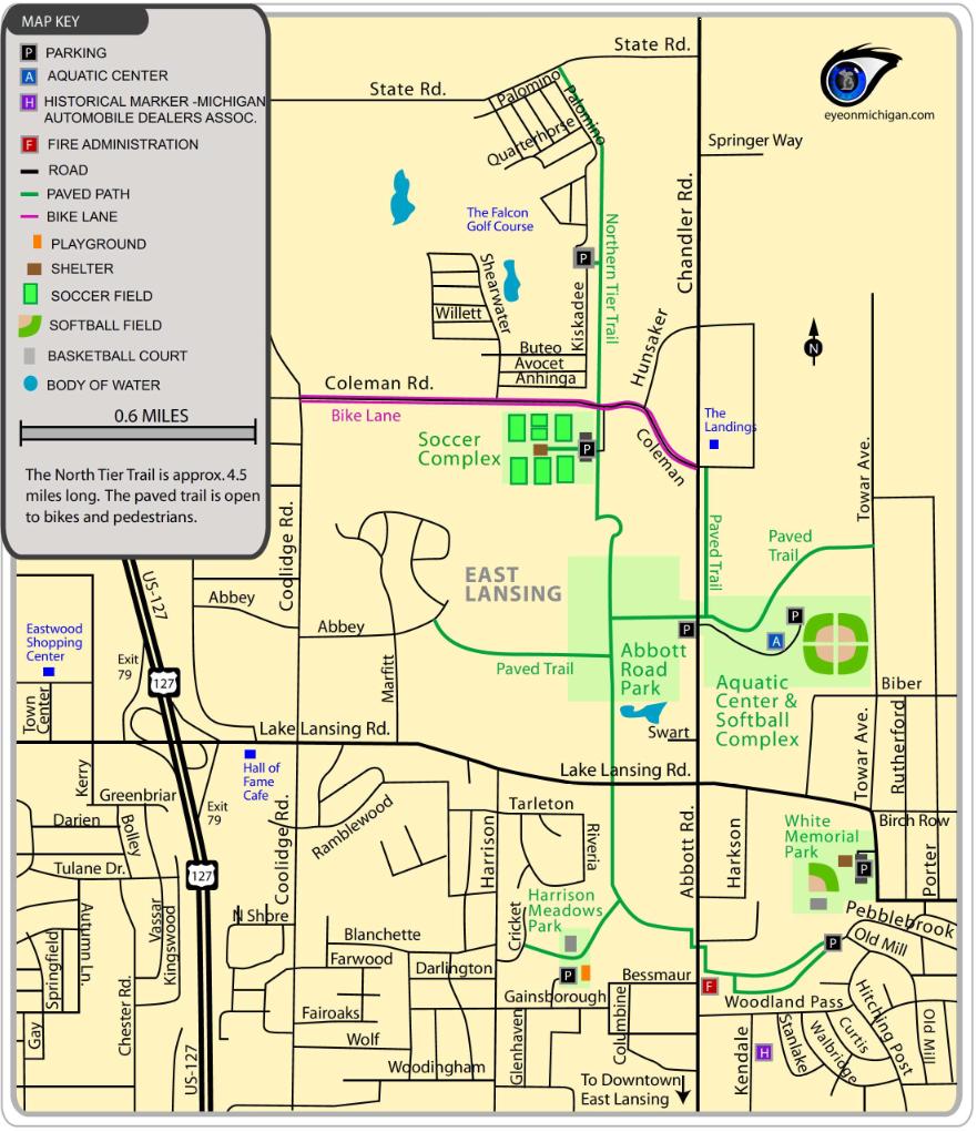 Map of East Lansing, showing key landmarks such as parks, bike lanes, soccer fields, and the Aquatic Center. Includes a scale indicating a 0.6-mile distance and notes about the North Tier Trail, which is approximately 4.5 miles long and open to bikes and pedestrians. Northern Tier Trail mountain bike trail.