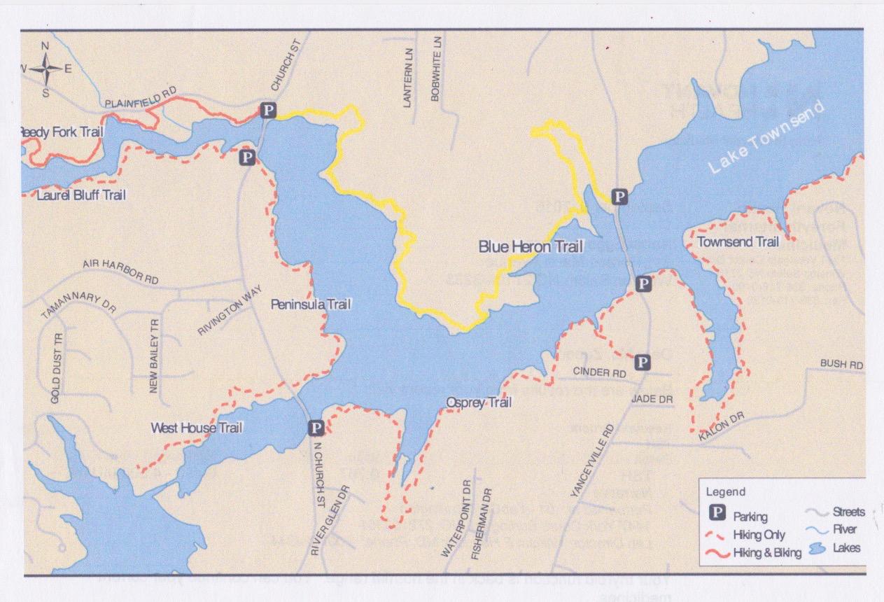 Map of hiking and biking trails around Lake Townsend, featuring the Blue Heron Trail, Peninsula Trail, and Osprey Trail. It includes marked parking areas and a legend indicating trails for hiking only and those suitable for both hiking and biking. The map outlines the water bodies and surrounding streets in the vicinity. Blue Heron mountain bike trail.