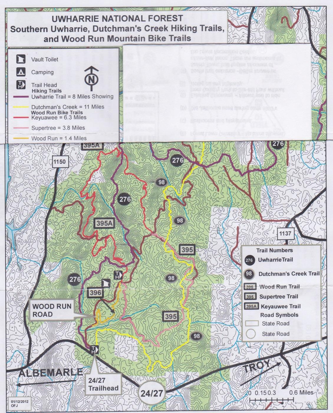 Map of Uwharrie National Forest showing hiking and mountain bike trails, including Southern Uwharrie, Dutchman's Creek, and Wood Run trails. Features include trail lengths, a trailhead location, and symbols for camping and toilets. Contours and roads are indicated for navigation. Uwharrie NF: Wood Run, Supertree And Keyauwee mountain bike trail.
