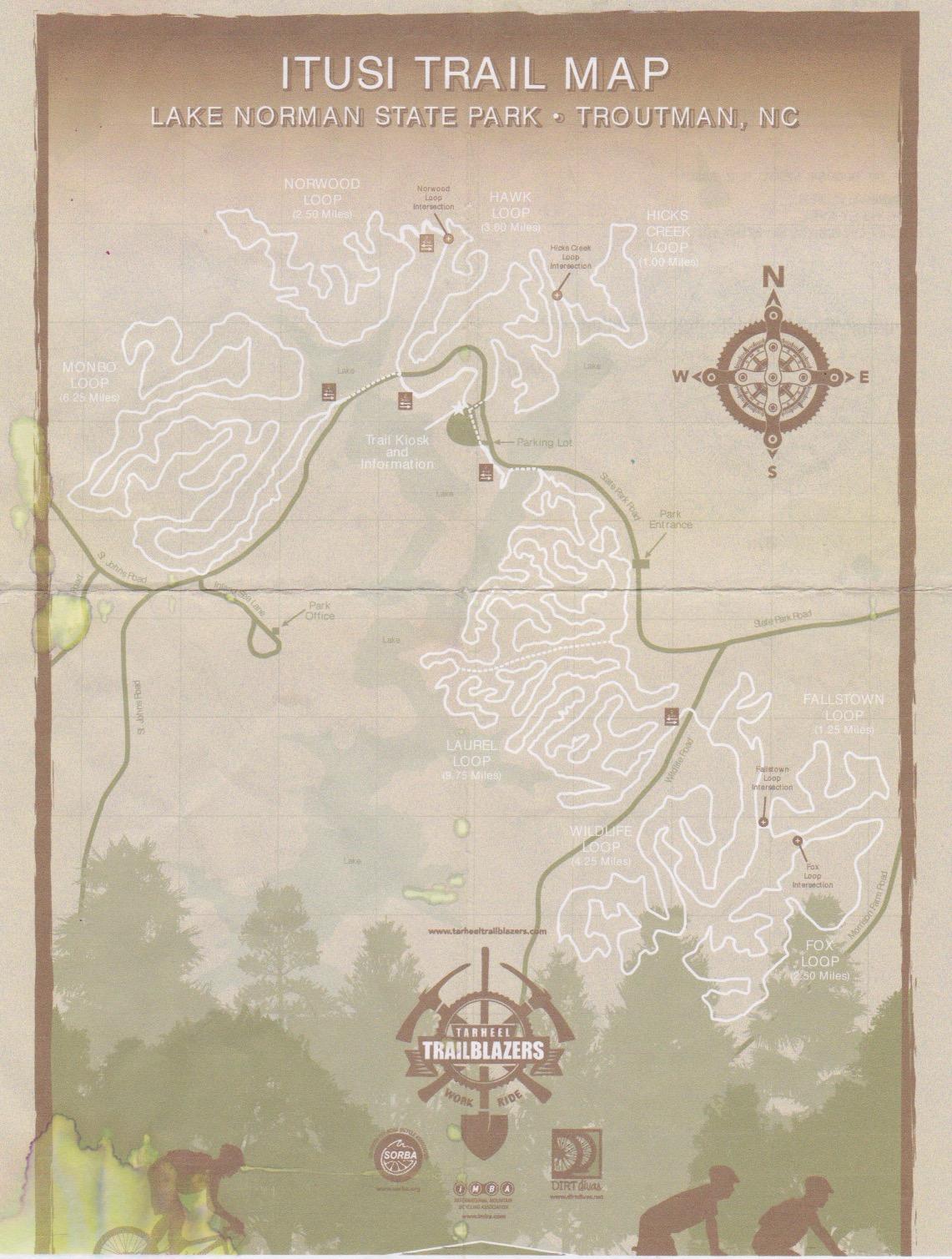 Alt text: "Trail map of Itusi Trail at Lake Norman State Park in Troutman, NC, featuring various trail loops such as Norwood Loop, Hawk Loop, and more, along with a compass rose indicating directions." Itusi @ Lake Norman State Park mountain bike trail.