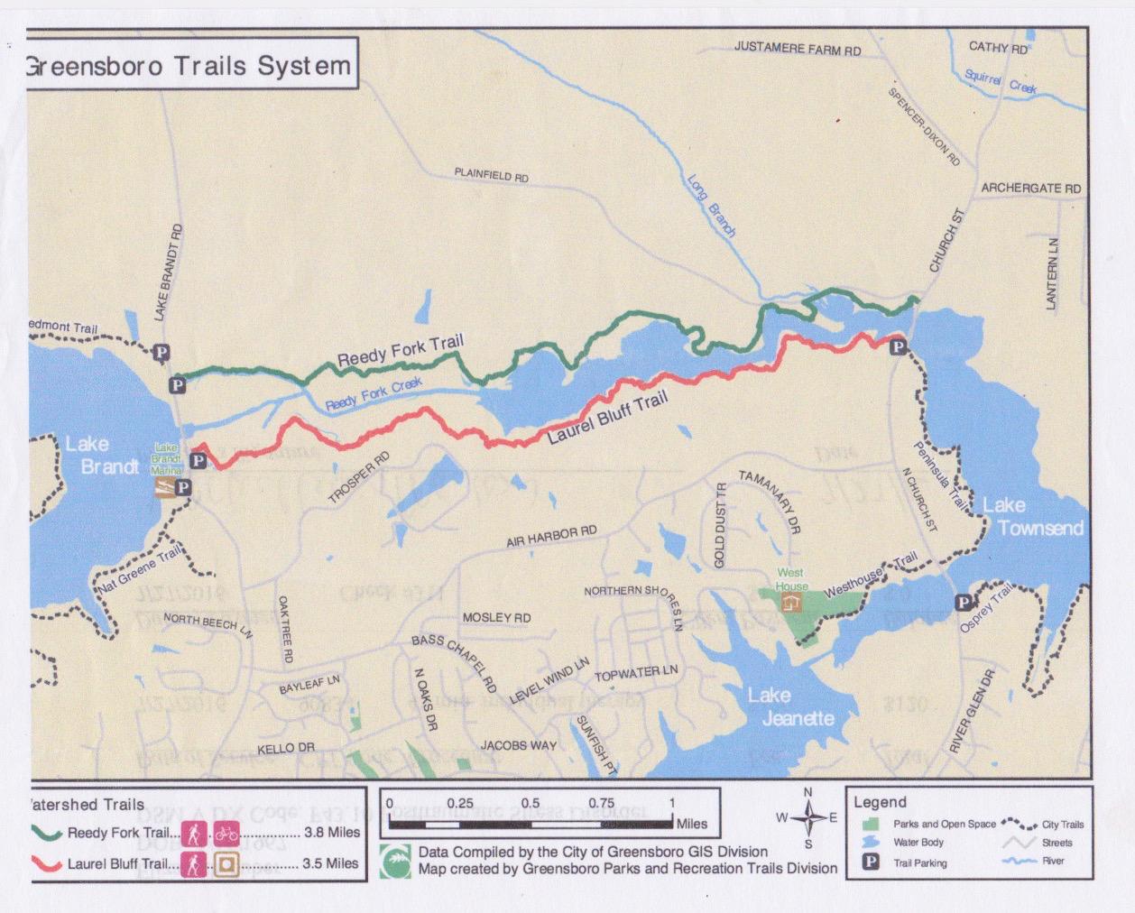 Map of the Greensboro Trails System, featuring the Reedy Fork Trail (green) and Laurel Bluff Trail (red). The map includes key landmarks such as Lake Brandt, Lake Townsend, and Lake Jeanette, along with trail lengths, parking areas, and other relevant features. Scale and legend provided for navigation. Reedy Fork mountain bike trail.