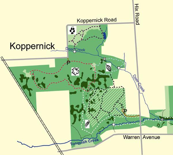 Map of the Koppernick area, showing trails, creeks, and parks. The map features marked pathways, including dotted and solid lines, and highlights points of interest such as Deer Creek and Tonquish Creek. Nearby roads, including Koppernick Road and Warren Avenue, are also indicated. William P. Holliday Forest and Wildlife Preserve mountain bike trail.