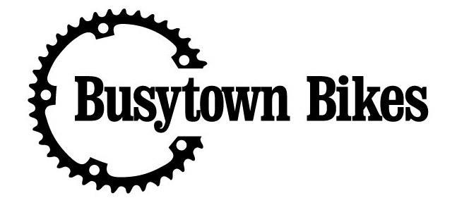 Logo of Busytown Bikes featuring a stylized bicycle chainring design intertwined with the company name, "Busytown Bikes," in bold black text.