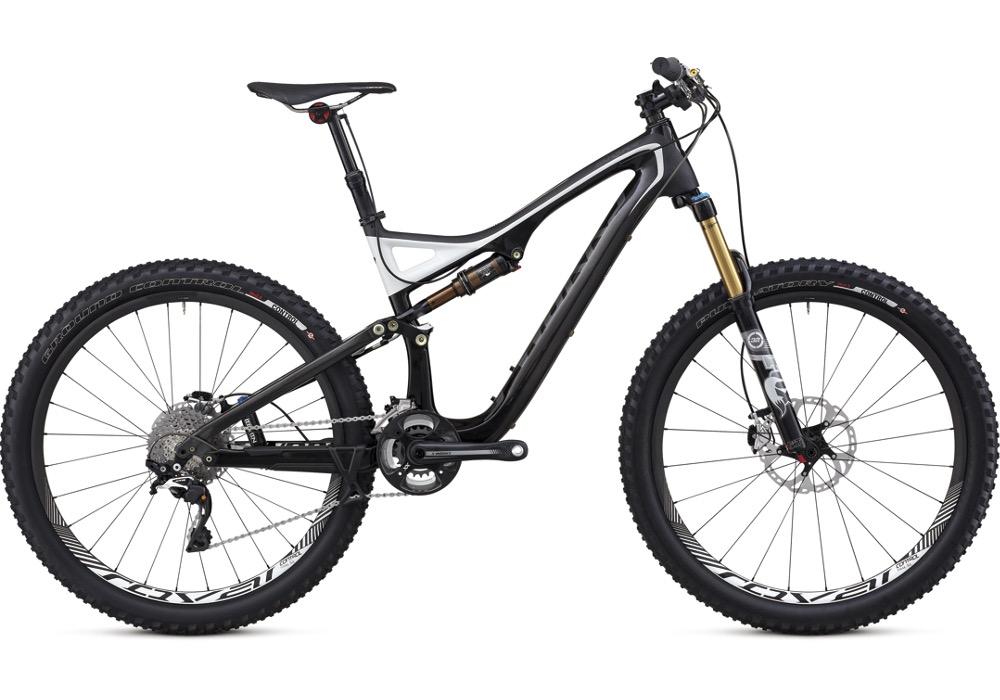 Specialized SWORKS Stumpjumper FSR: A high-performance mountain bike with a sleek black and gray frame, featuring thick tires suited for rugged terrain. The bike has a lightweight design, a modern suspension system, and multiple gears for versatile riding.
