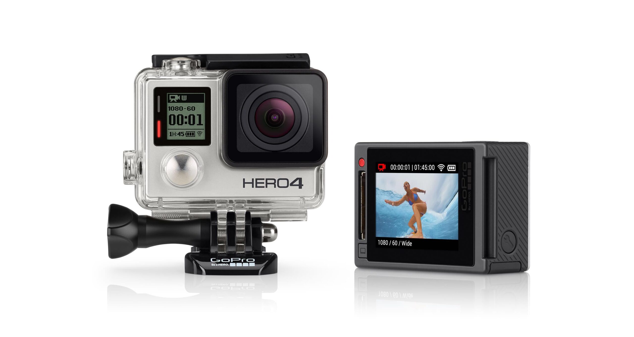 GoPro GoPro Hero 4 Silver: Image of a GoPro HERO4 camera with a clear protective case, featuring a digital display showing recording settings. Next to it is a separate back screen displaying a scene of a person surfing. The camera is mounted on a small base for stability.