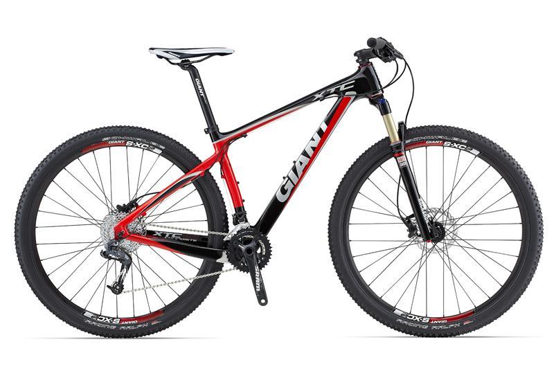Giant XTC 29er: Mountain bike featuring a sleek design with a black and red color scheme, equipped with disc brakes, a lightweight frame, and wide tires for off-road performance. Ideal for adventurous trails.