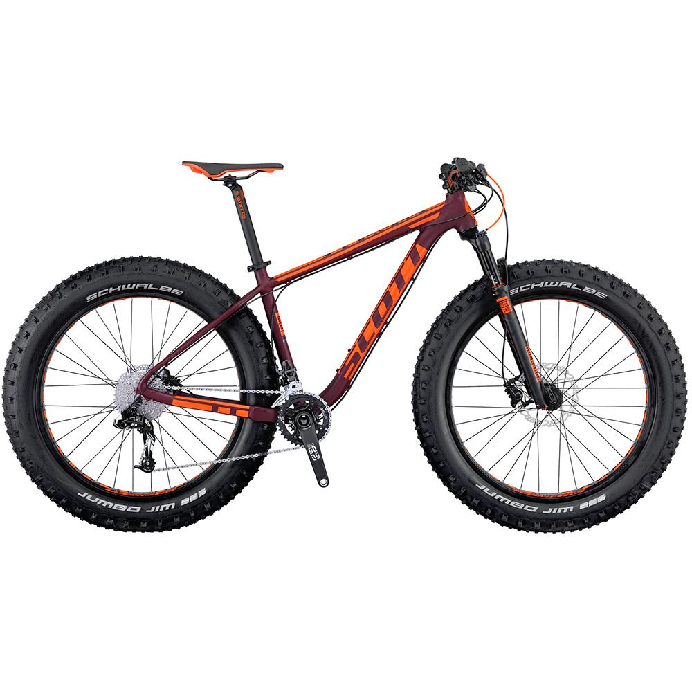 Scott Big Ed: A Scott fat bike featuring a purple and orange design, with wide tires suitable for off-road riding. The bike includes a sleek frame, high-quality components, and an adjustable seat height, designed for durability and performance on varied terrains.