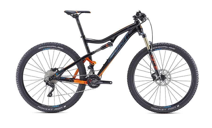 Fuji Rakan: A black and orange mountain bike with a sleek design, featuring thick tires, a front suspension fork, and disc brakes. The bike is positioned on a plain background, showcasing its frame and components.