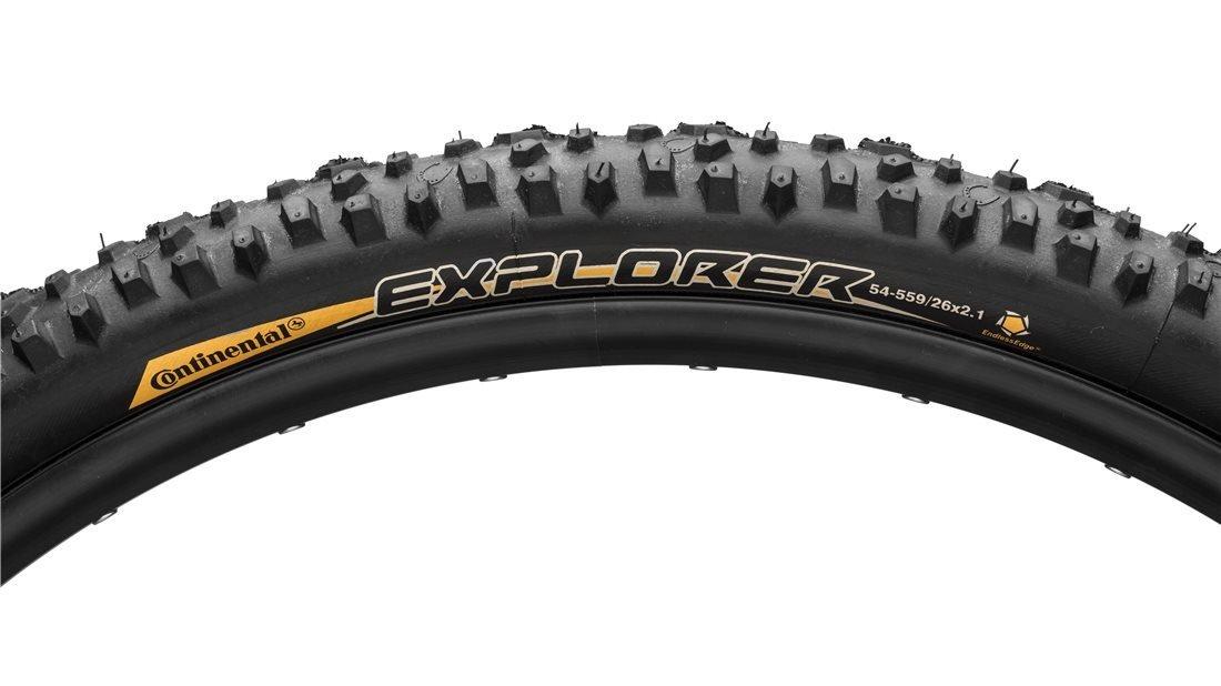 Continental Explorer: Alt text: Close-up of a mountain bike tire labeled "Explorer" by Continental, showing detailed tread pattern and specifications including size 26 x 2.1.