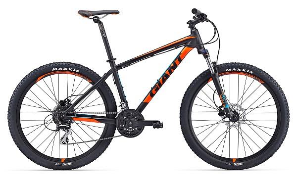 Giant Talon 27.5: A black and orange mountain bike with thick tires, disc brakes, and a lightweight frame, designed for off-road riding. The bike features a prominent "Giant" logo and a sturdy build, ideal for outdoor adventures.