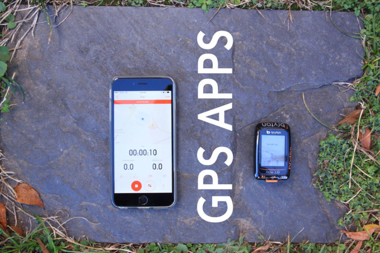 A smartphone displaying a GPS app's interface and a Bryton GPS cycling device placed on a stone surface, surrounded by grass and leaves. The text "GPS APPS" is prominently featured in the image.