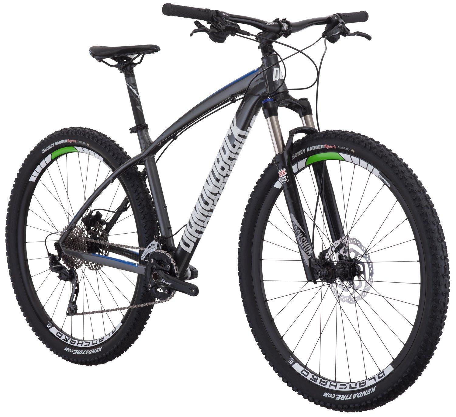 Diamondback Overdrive Comp 29er: Mountain bike featuring a sleek black and gray frame, equipped with wide tires and a front suspension fork, designed for off-road cycling. The bike is positioned at an angle to showcase its features, including a drivetrain with visible gears and disc brakes.