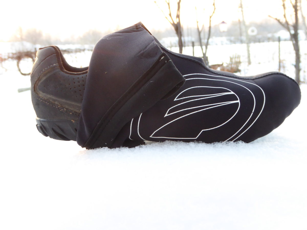 You don't need special shoes. Neoprene shoe covers are reasonably priced and will keep your toes toasty.