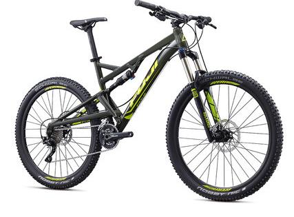 Fuji Fuji Reveal 1.1: A green and black mountain bike with thick tires, a dual suspension frame, and front disc brakes, positioned on a white background.