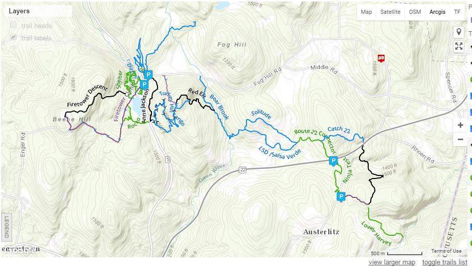 Map showing various hiking and biking trails in a mountainous area, with trail names labeled in different colors (black, blue, green, purple). Parking locations are indicated with 'P' symbols. The map includes contour lines to represent elevation changes and features nearby roads. Beebe Hill State Forest mountain bike trail.