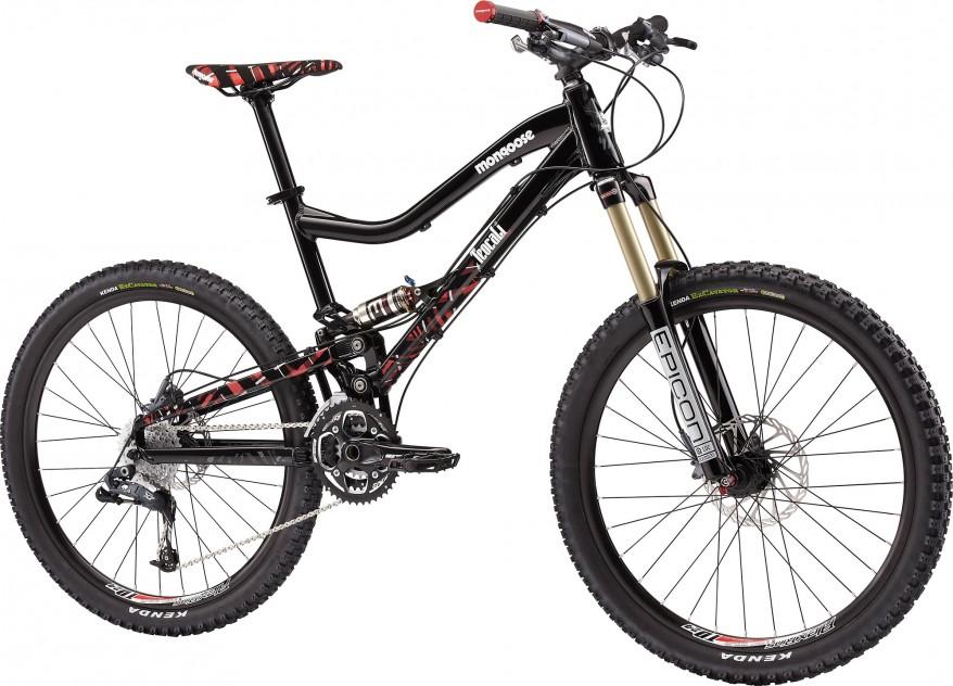 Mongoose Teocali Comp: Alt text: A black mountain bike with red and white accents, featuring a full suspension frame, knobby tires, and a front fork with gold-colored stanchions. The bike has disc brakes and a chainring, showcasing its design for off-road cycling.