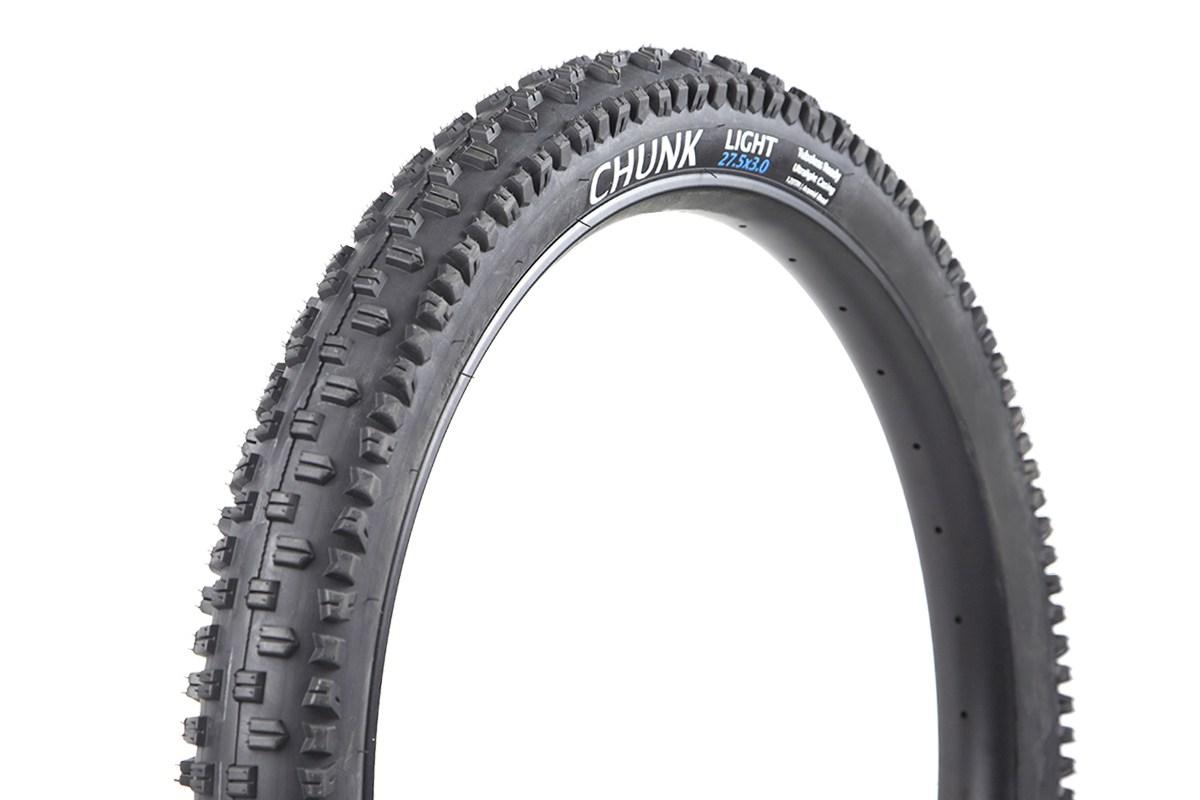 Terrene Chunk: Alt text: A close-up view of a mountain bike tire labeled "CHUNK LIGHT 27.5x3.0," featuring a knobby tread pattern designed for off-road traction.