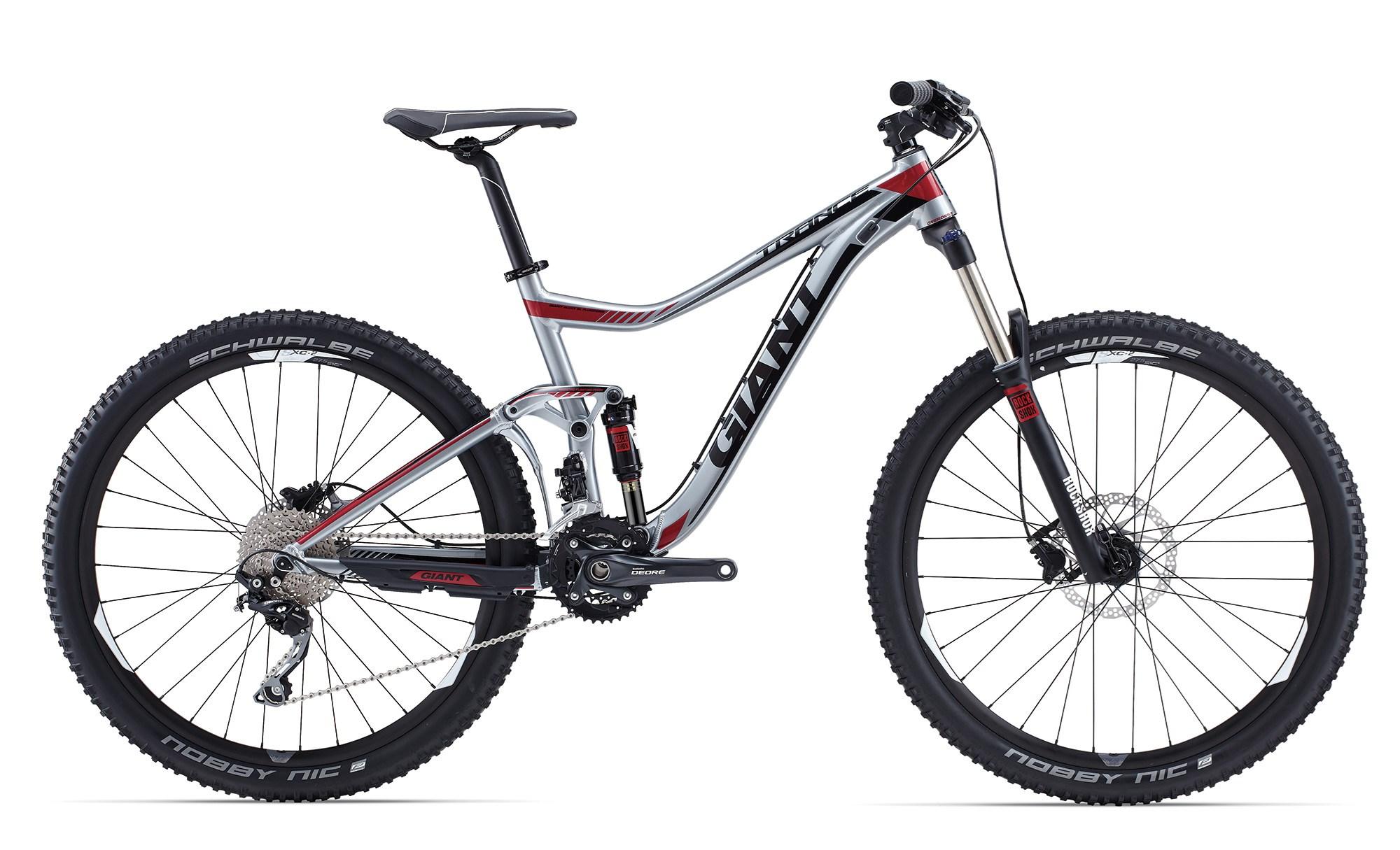 Giant trance 3: Alt text: A modern mountain bike with a sleek silver and red frame, featuring wide tires and disc brakes, positioned against a white background.