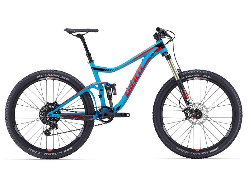 Giant Trance SX 27.5: A blue and red mountain bike with a sleek design, featuring wide tires, a front suspension fork, and a modern frame. The bike is equipped with disc brakes and a gear system, showcasing its suitability for off-road trails.