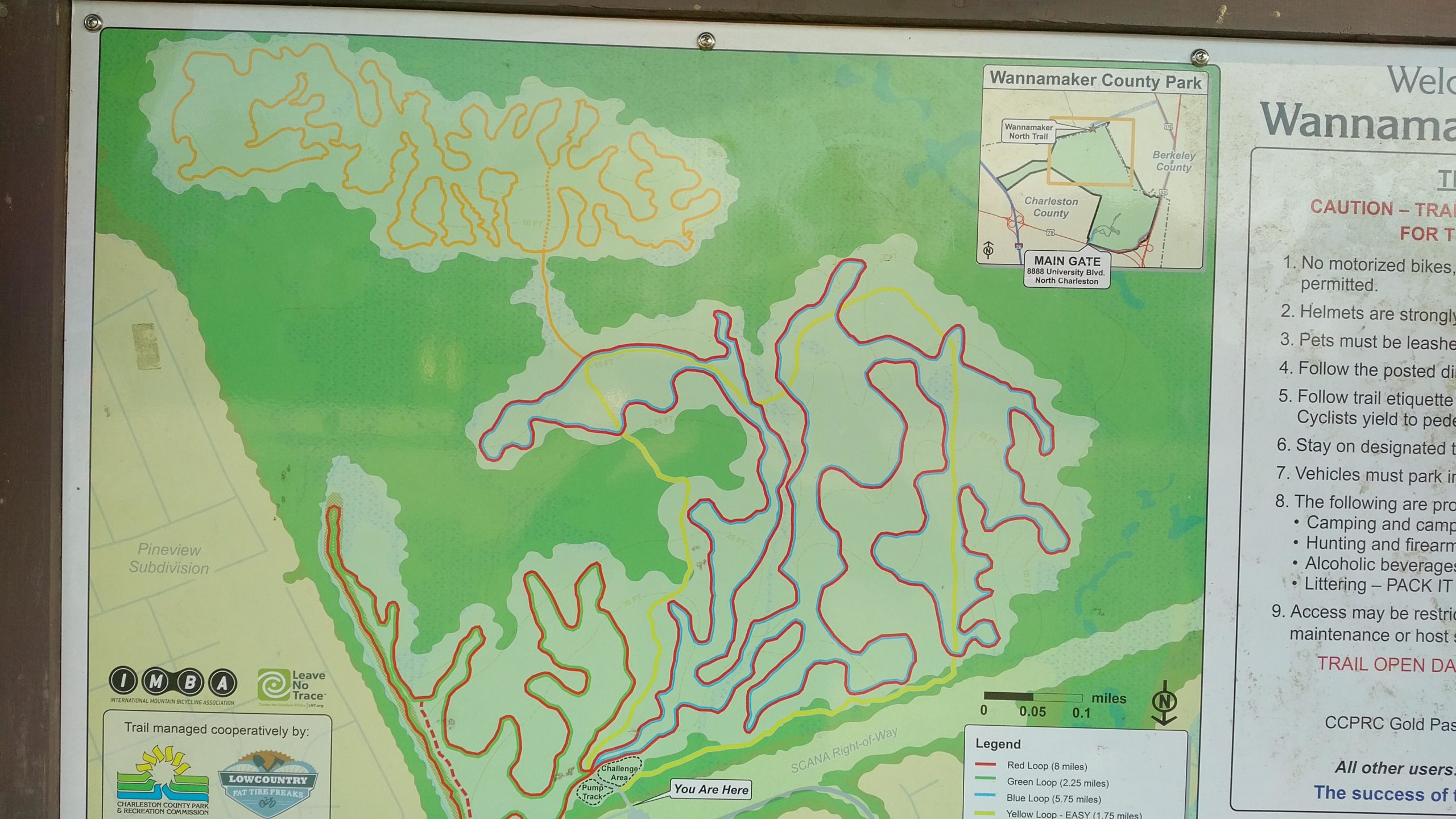 Map of Wannamaker County Park detailing various trails, including the red, yellow, green, and blue loops, with a "You Are Here" marker. The map also includes park guidelines and a small inset showing the park's location within Charleston and Berkeley counties. Wannamaker Park mountain bike trail.