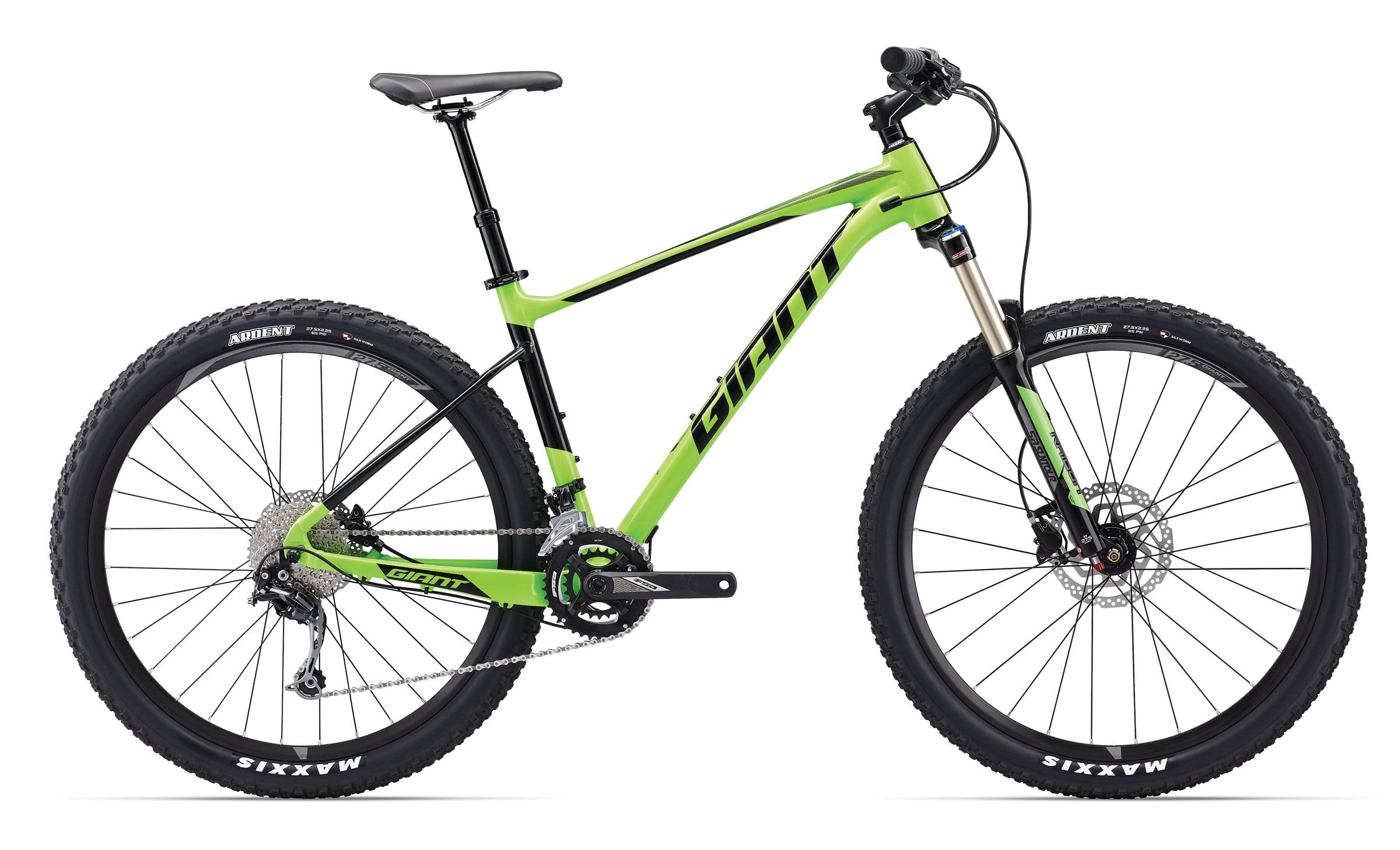 Giant Giant Fathom: Mountain bike with a bright green and black frame, featuring a front suspension fork, disc brakes, and rugged tires designed for off-road terrain.