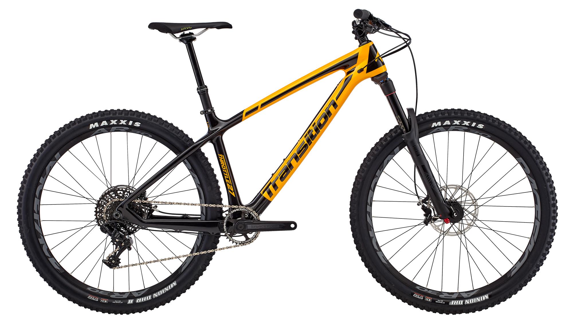 Transition Throttle: A black and yellow mountain bike with a sleek design, featuring wide tires labeled "Maxxis." The bike is positioned to showcase its frame, drivetrain, and disc brakes. The handlebars have a minimalistic setup, and the saddle is streamlined for comfort.