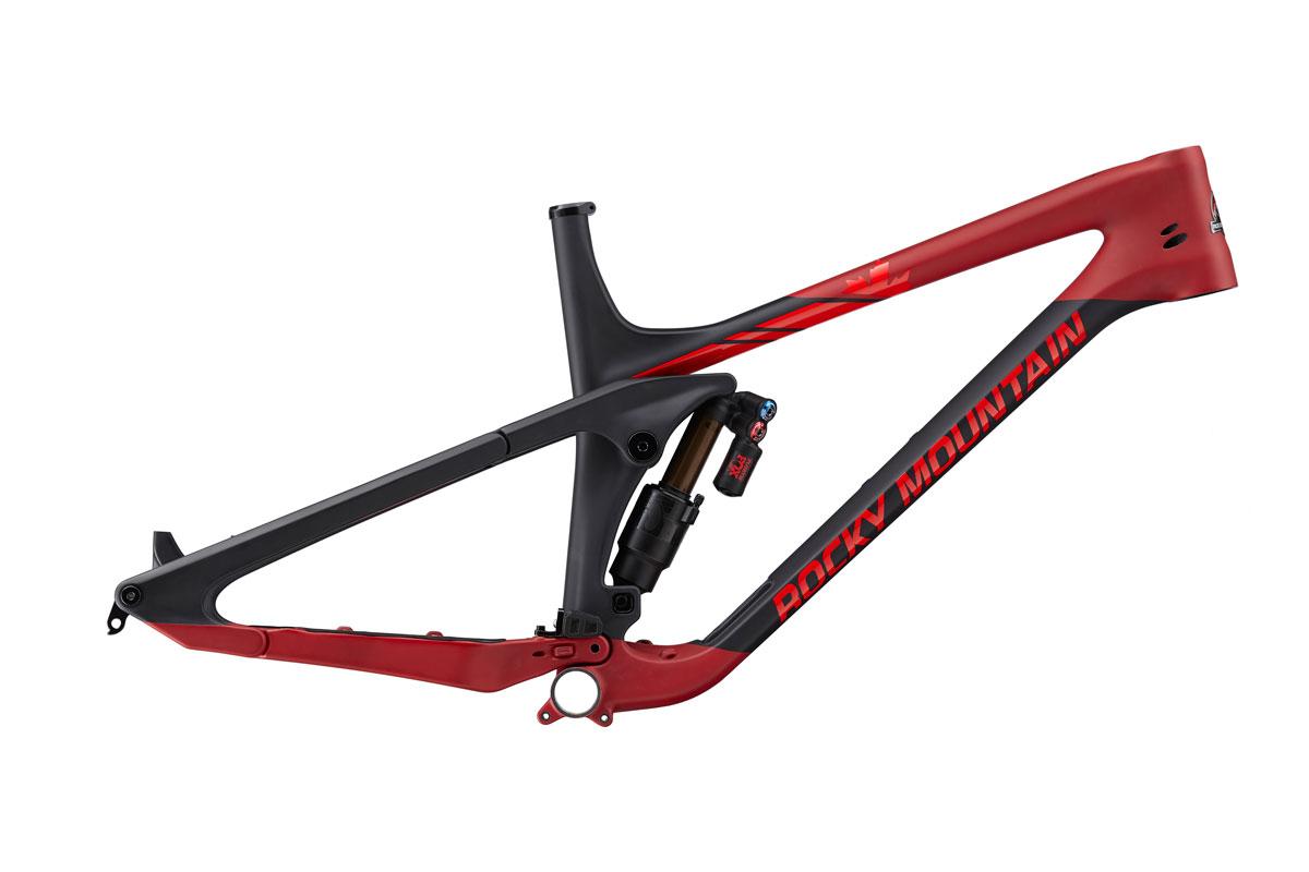 Rocky Mountain Slayer: A sleek mountain bike frame in black and red, featuring a prominent "Rocky Mountain" logo, with visible suspension components and an aerodynamic design. The frame is showcased against a neutral background, emphasizing its modern craftsmanship and sporty aesthetic.