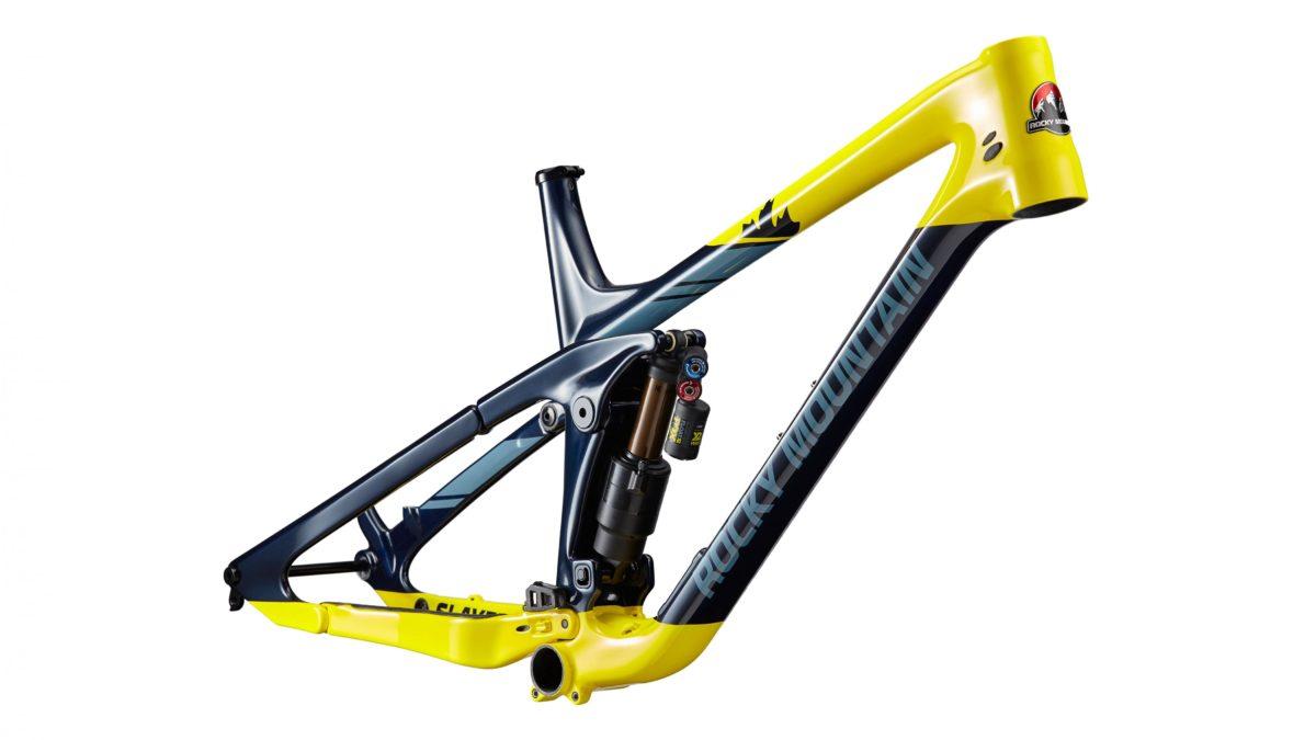 Rocky Mountain Slayer: Mountain bike frame in blue and yellow with a shock absorber, showcasing a modern design for performance and durability.