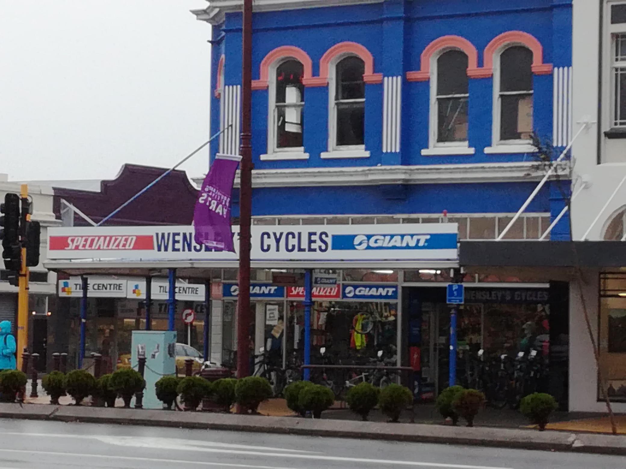 A street view of a bicycle shop named "Wensley